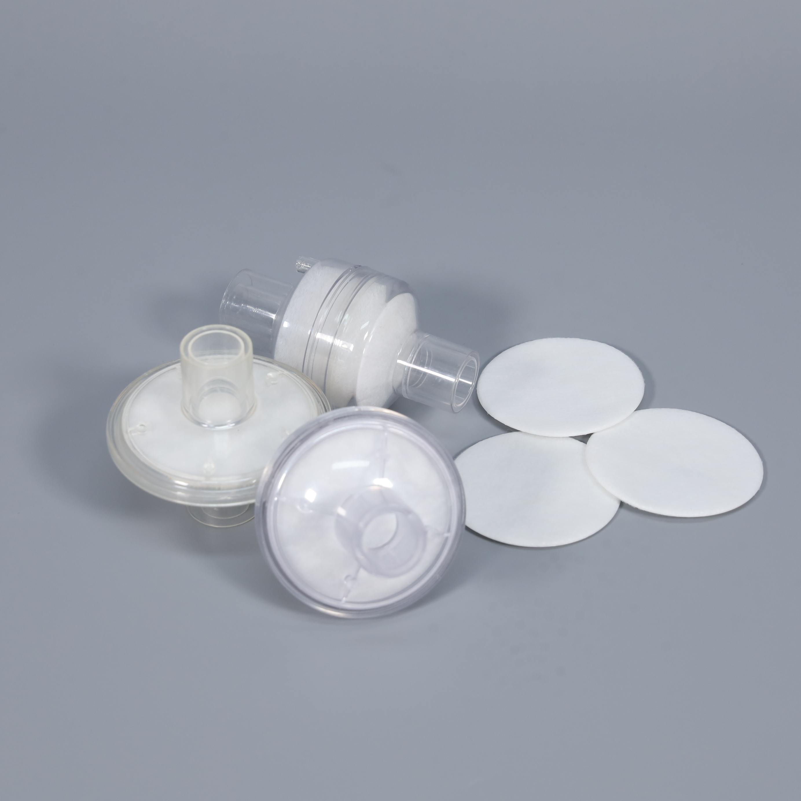 Round nonwoven filter pads for CPAP and oxygen concentrator components