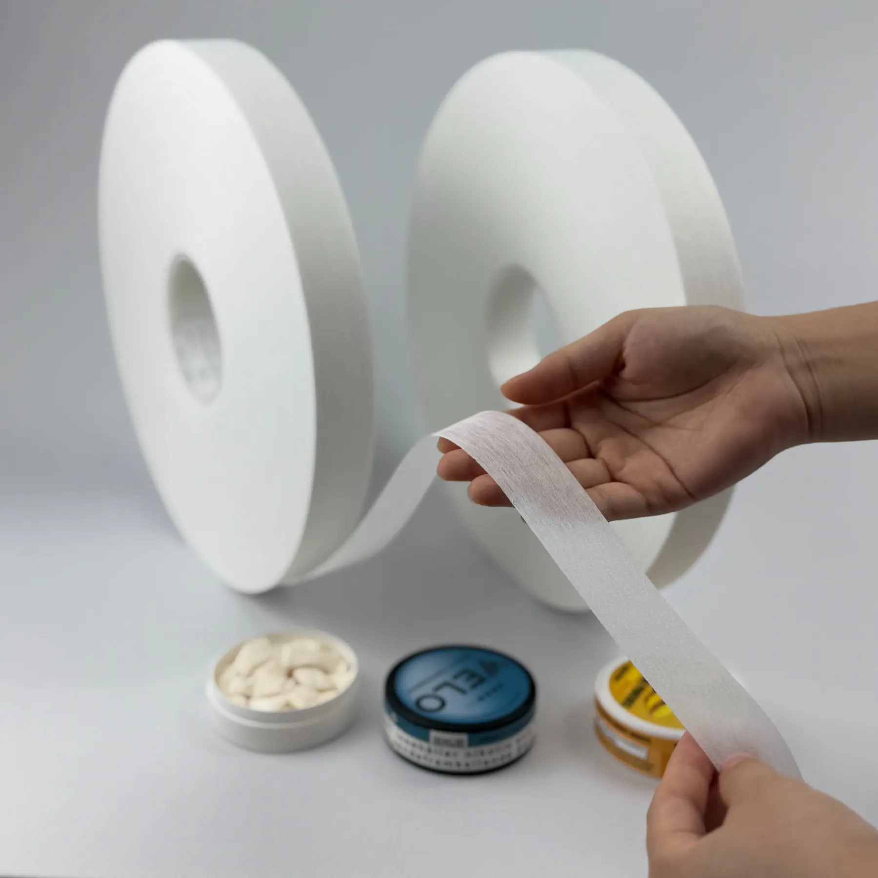 Close-up handling view of low-fiber-shedding pouch nonwoven material