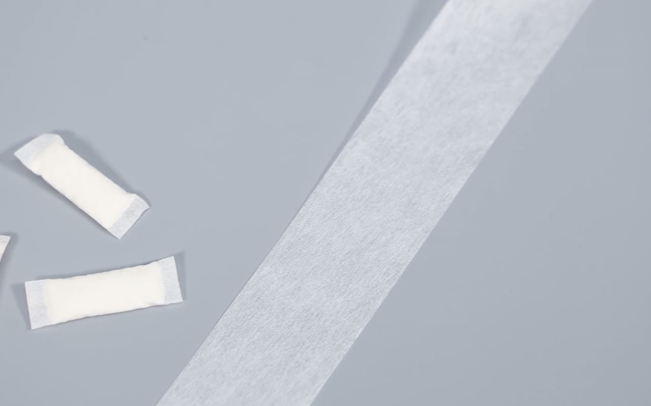 Pouch-grade nonwoven material strip showing texture and surface quality for heat-sealed pouch production